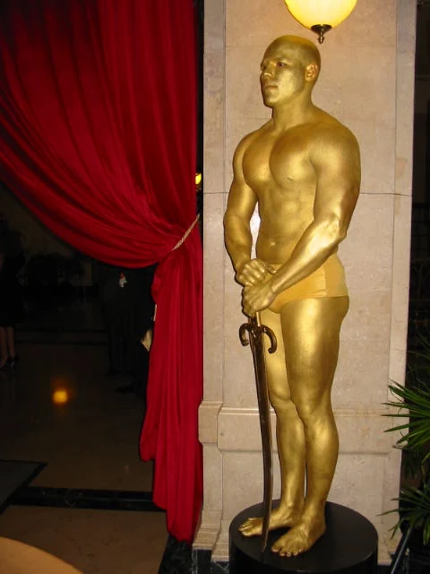 Performer in a full gold sculpted character costume