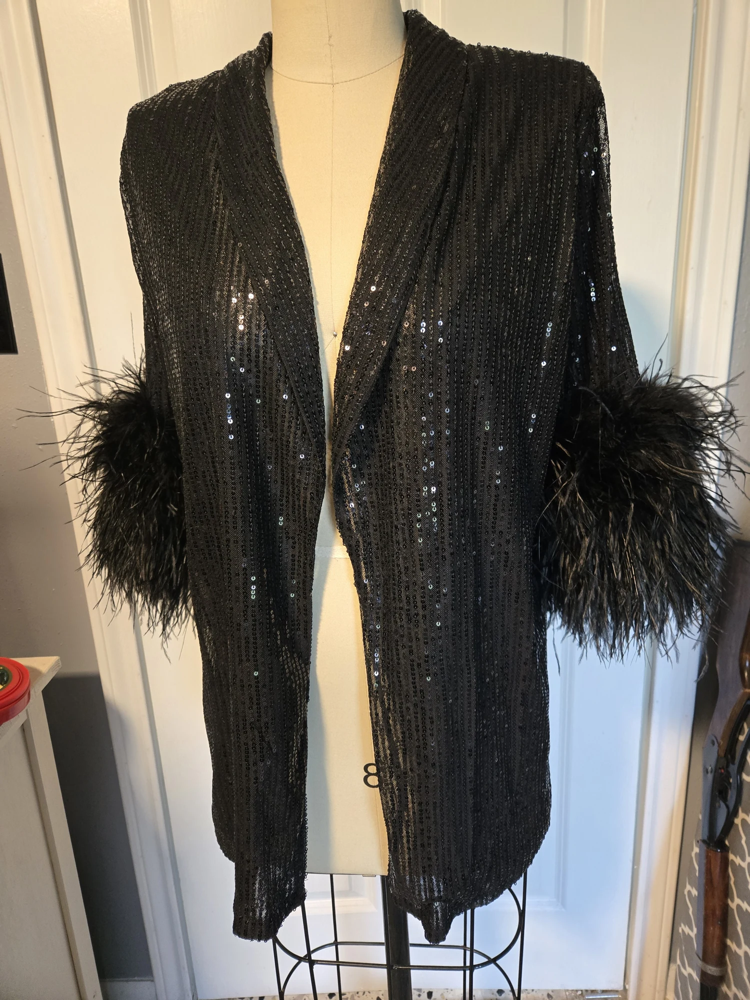 Black textured costume panels with feathered trim