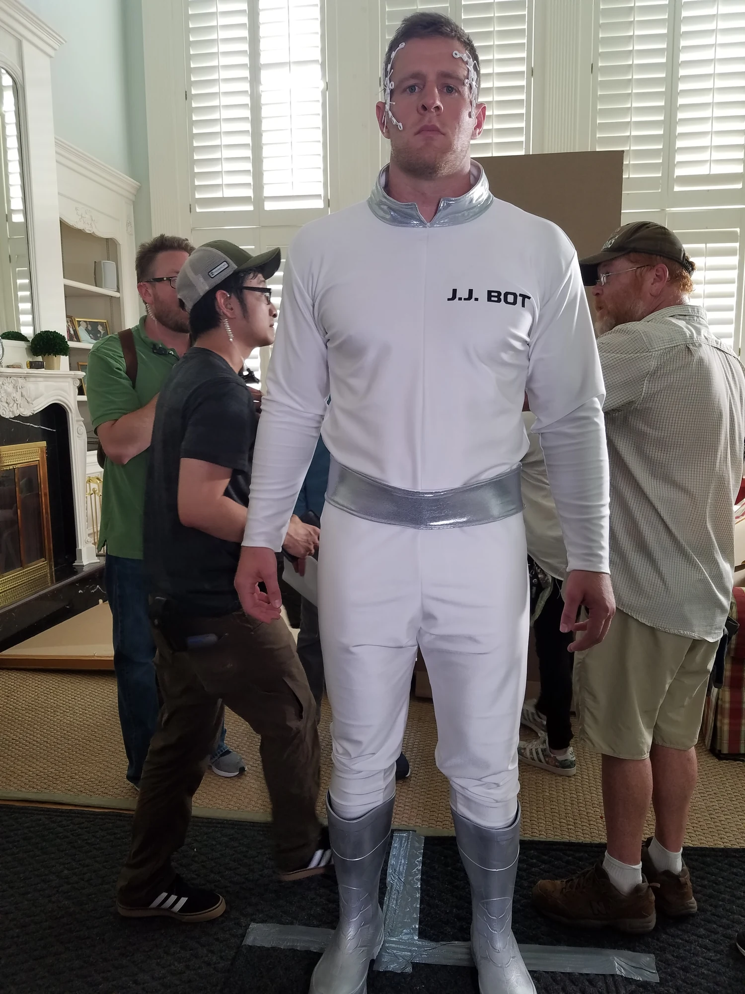 Performers wearing coordinated white futuristic costumes