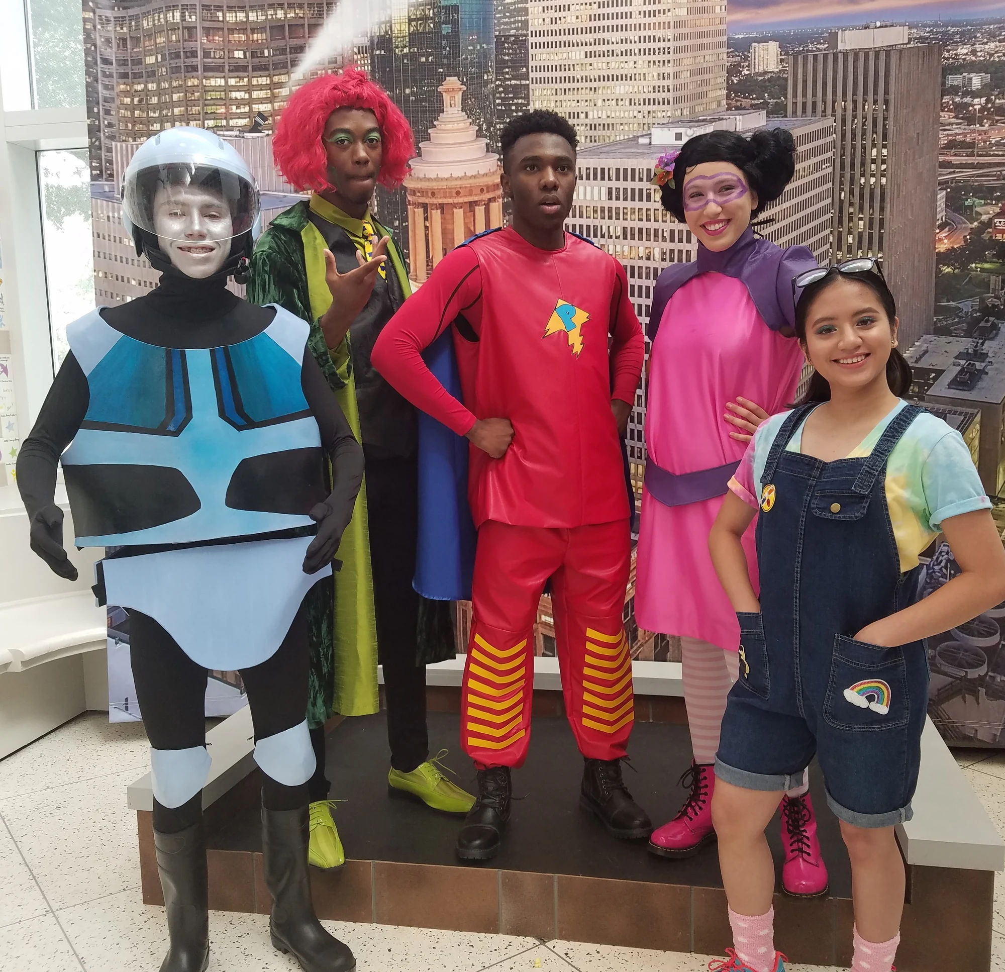 Group wearing five colorful character costumes